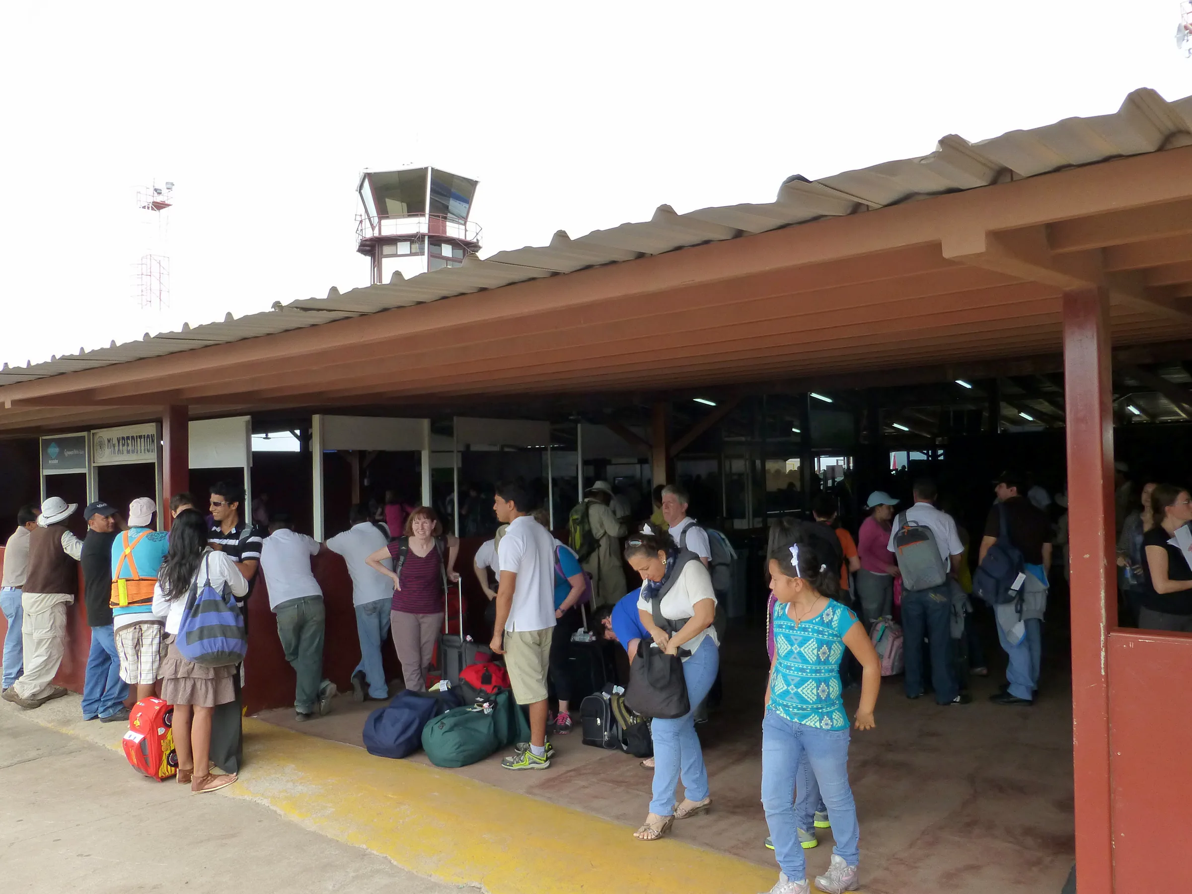 At the airport, awaiting the public bus to the ferry from Baltra to Santa Cruz Islands.