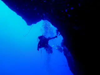Looking out of the cavern from its largest exit point to the vertical reef wall.  On this dive, we entered the cavern through this hole because high surf precluded a reef top entry.