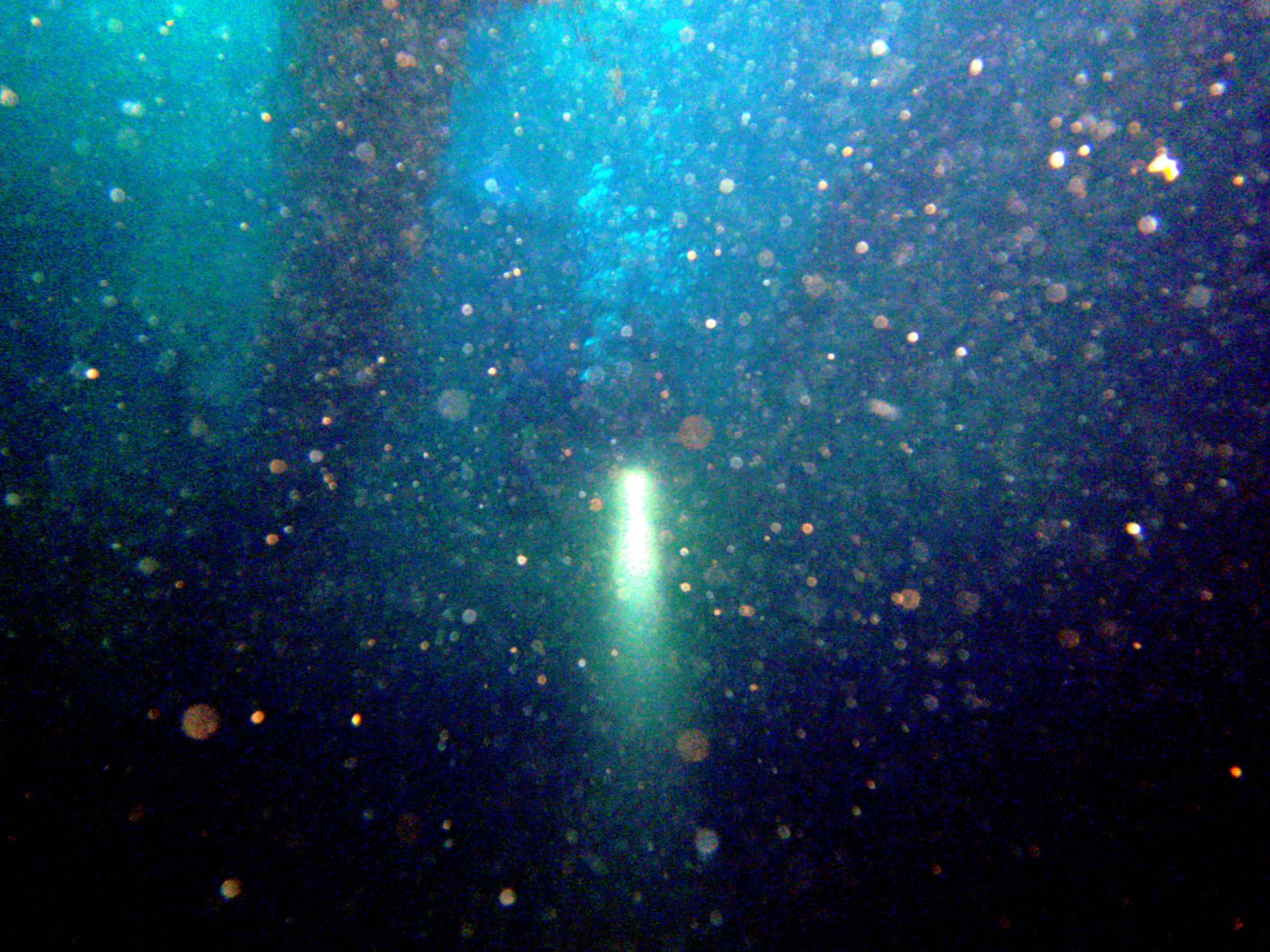 Penetrating the wreck's cargo holds.  The silt in the water causes back scatter from my flash.