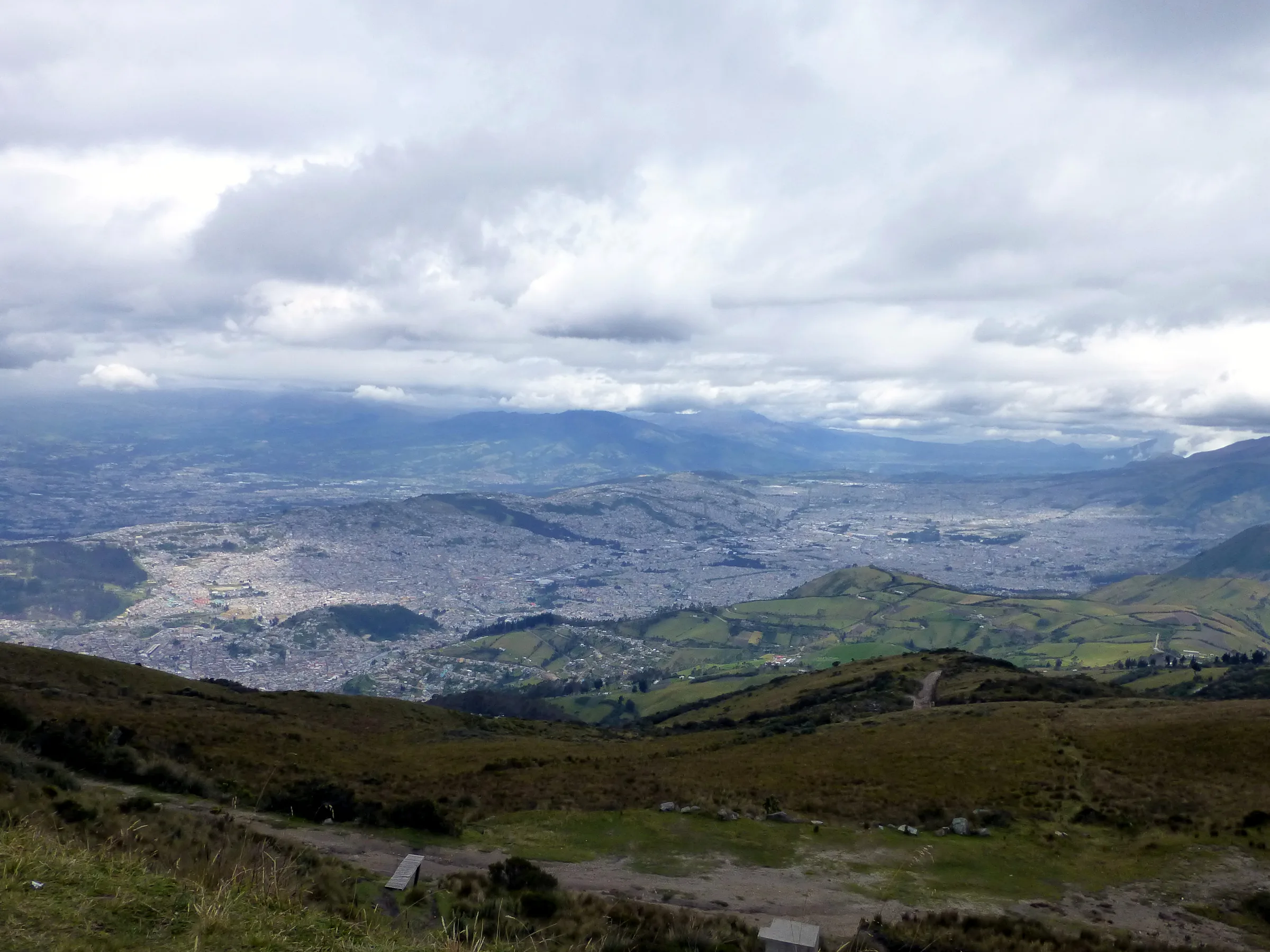 View of Quito far below, stretching along a valley about 22 miles long by 2 - 3 miles wide. The top of the El Teleferico is 4,050 meters high, far above timberline.