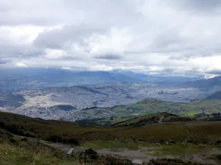 View of Quito far below, stretching along a valley about 22 miles long by 2 - 3 miles wide.   The top of the El Teleferico is 4,050 meters high, far above timberline.