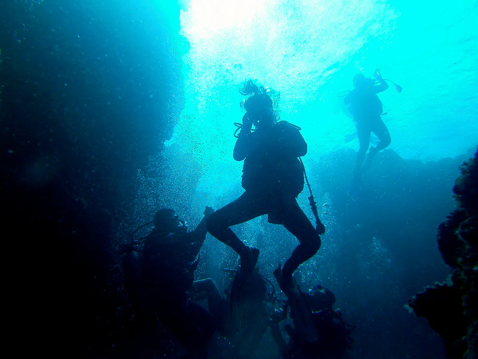 Traffic Jam.  Divers descend through one of the blue holes.