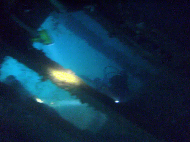 Flash light beams illuminate our way through the cargo holds.