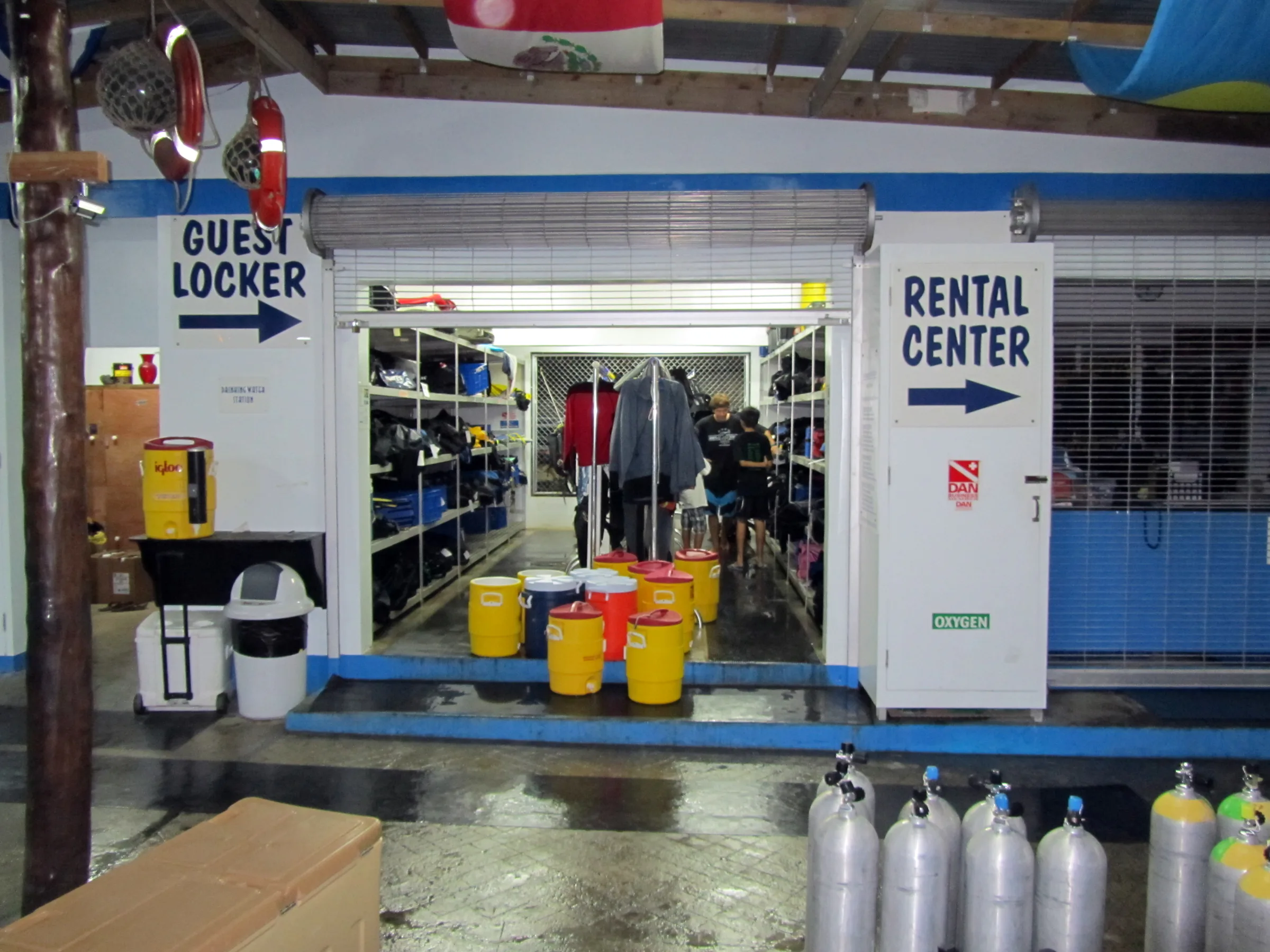 Guest locker at the end of the day, with the gear in storage and the boat's water coolers awaiting refilling for the next day's diving.