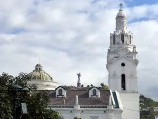 Church on Plaza de la Independencia (Plaza Grande), beside the Presidential Palace. Winged madonna statue is in the distance on the hilltop.