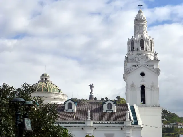 Church on Plaza de la Independencia (Plaza Grande), beside the Presidential Palace.  Winged madonna statue is in the distance on the hilltop.