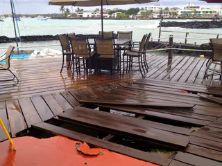 An overnight high tide and storm surge damaged the wooden deck.