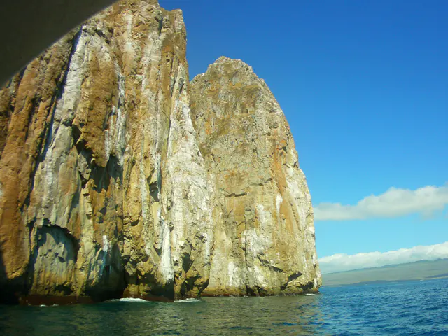 The sheer cliffs of Kicker Rock.  Note it's quite a distance from the shore of San Cristobal Island.  The open ocean allows for the viewing of deep water fish who come up to feed in shallower water along the sheer cliffs beneath the surface.