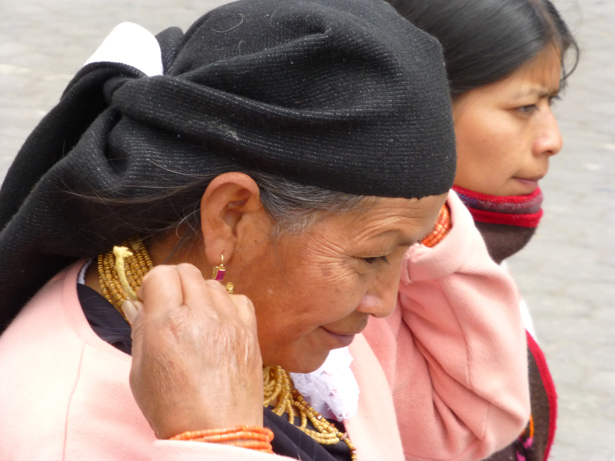 Otavalo woman with gold necklaces and earrings.