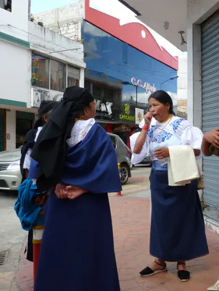 Women await the festival in Cotacachi.   Per wikitravel.org website, "Cotacachi Village is a small town of 20.000 inhabitants some 20km north of Otavalo. The town is famous for its leather goods."