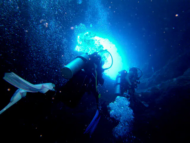 Exiting the cavern through one of the two holes leading to a dive along the reef wall (that extends to the Blue Corner).