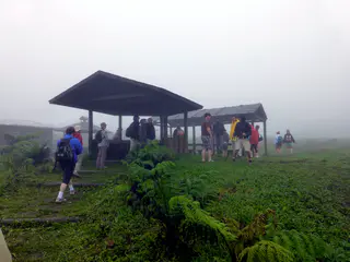 Ranger station and the beginning point of our hike.  Sean stands in the center in a t-shirt and shorts (and no rain gear).  Amazingly, he did quite well traveling so lightly on the hike.