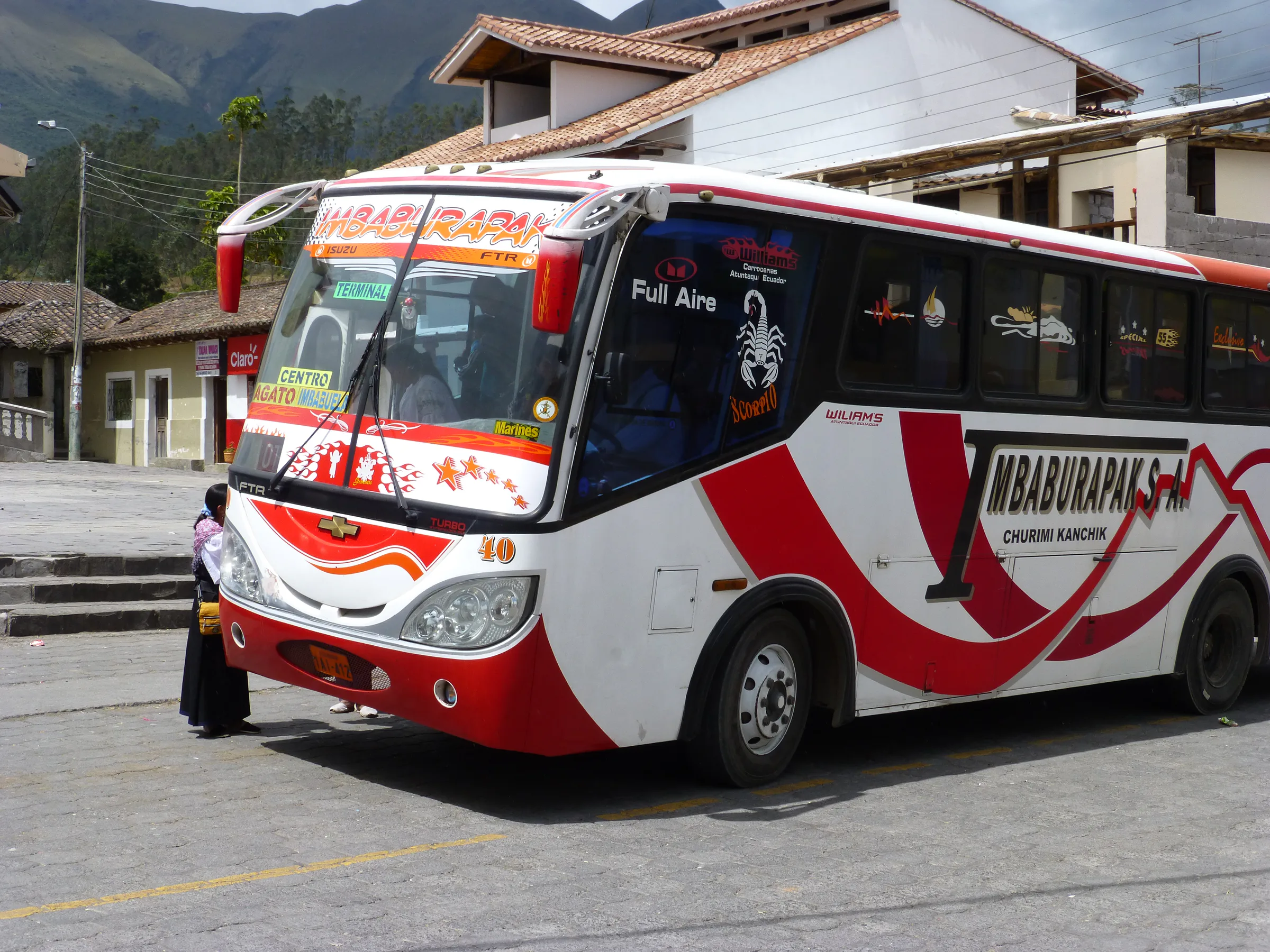 A colorful bus stops in Otavalo outside of the shop of the Jose Ruiz Perugachi family.