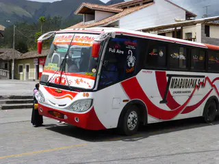 A colorful bus stops in Otavalo outside of the shop of the Jose Ruiz Perugachi family.