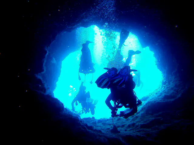 Exiting the cavern through one of the two holes that lead to a dive along the reef wall (that extends to the Blue Corner).