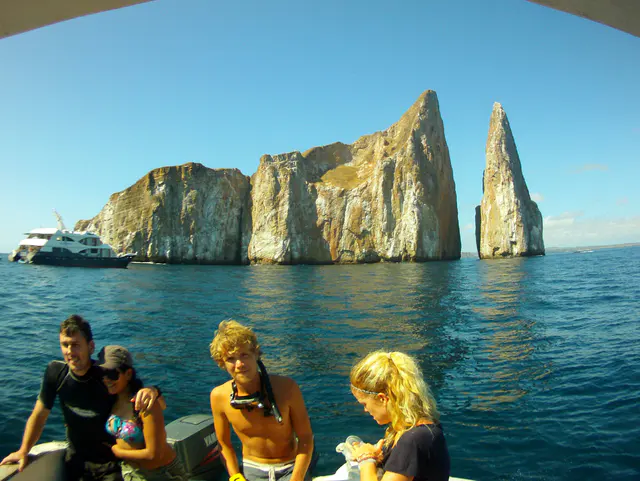 Kicker Rock is in two pieces, and we snorkeled in the passageway between the two.  A cruise ship boat is on the left of the photo. This photo was taken with my Intova Sport HD, a camera similar to the Go Pro.