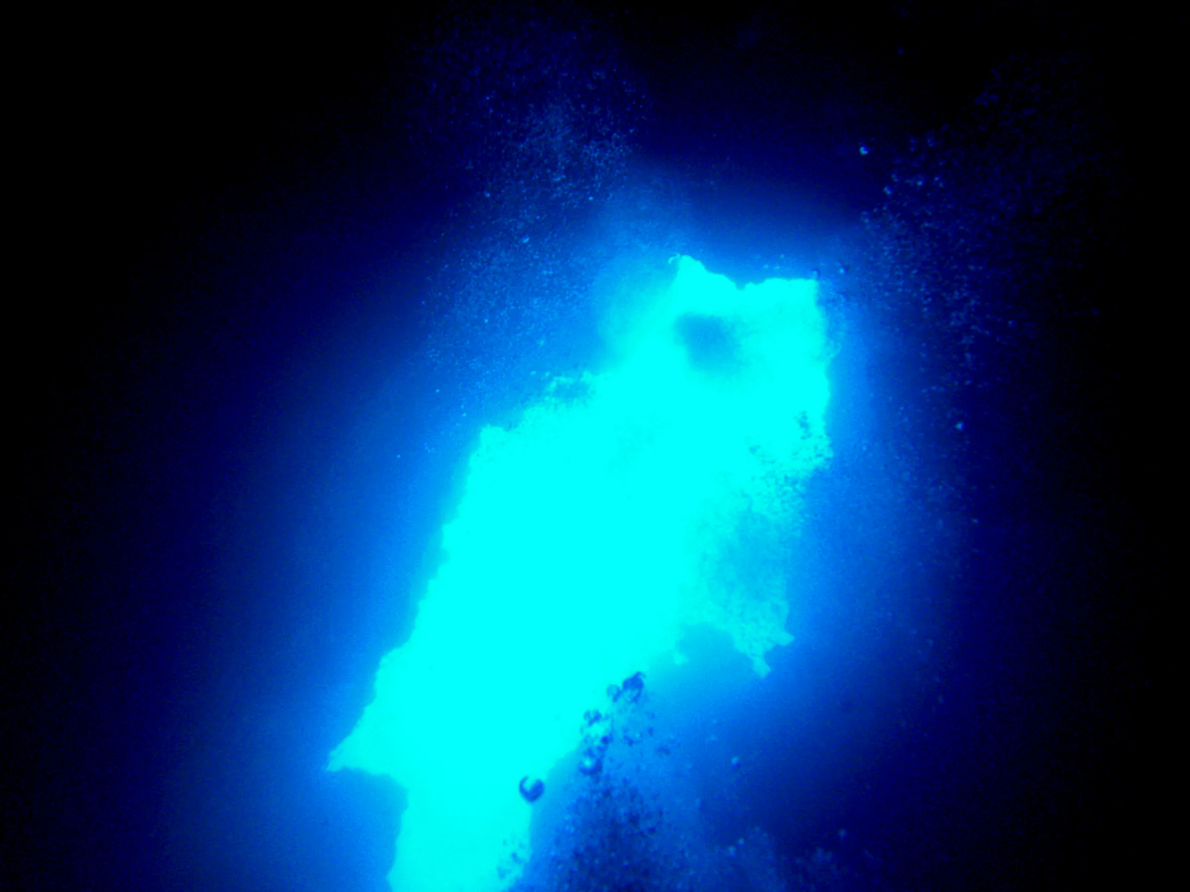 Looking from the cavern up at the entrance to the Virgin Blue Hole, Palau, at about 90'.