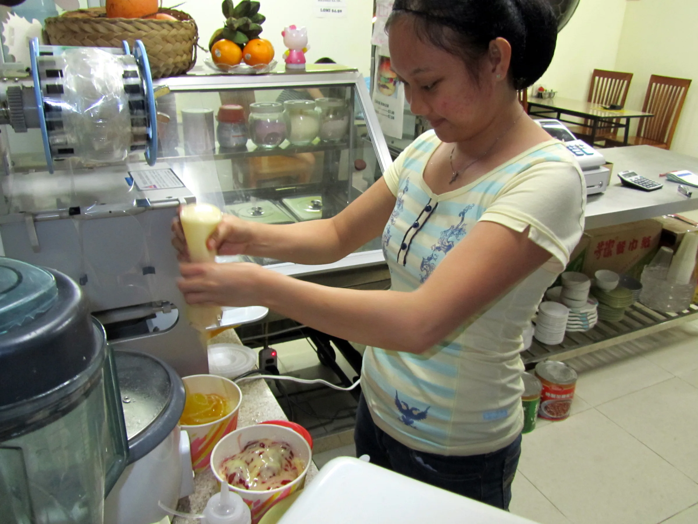 "I Love Noodles" Restaurant. Making a stawberry fruit ice, a mix of crushed ice, smuckers strawberry jam, beans, and vanilla sauce, topped with a scoop of neopolitan ice cream.