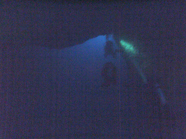 Moving from darkness toward the distant underwater exit of the Virgin Blue Hole, Palau.