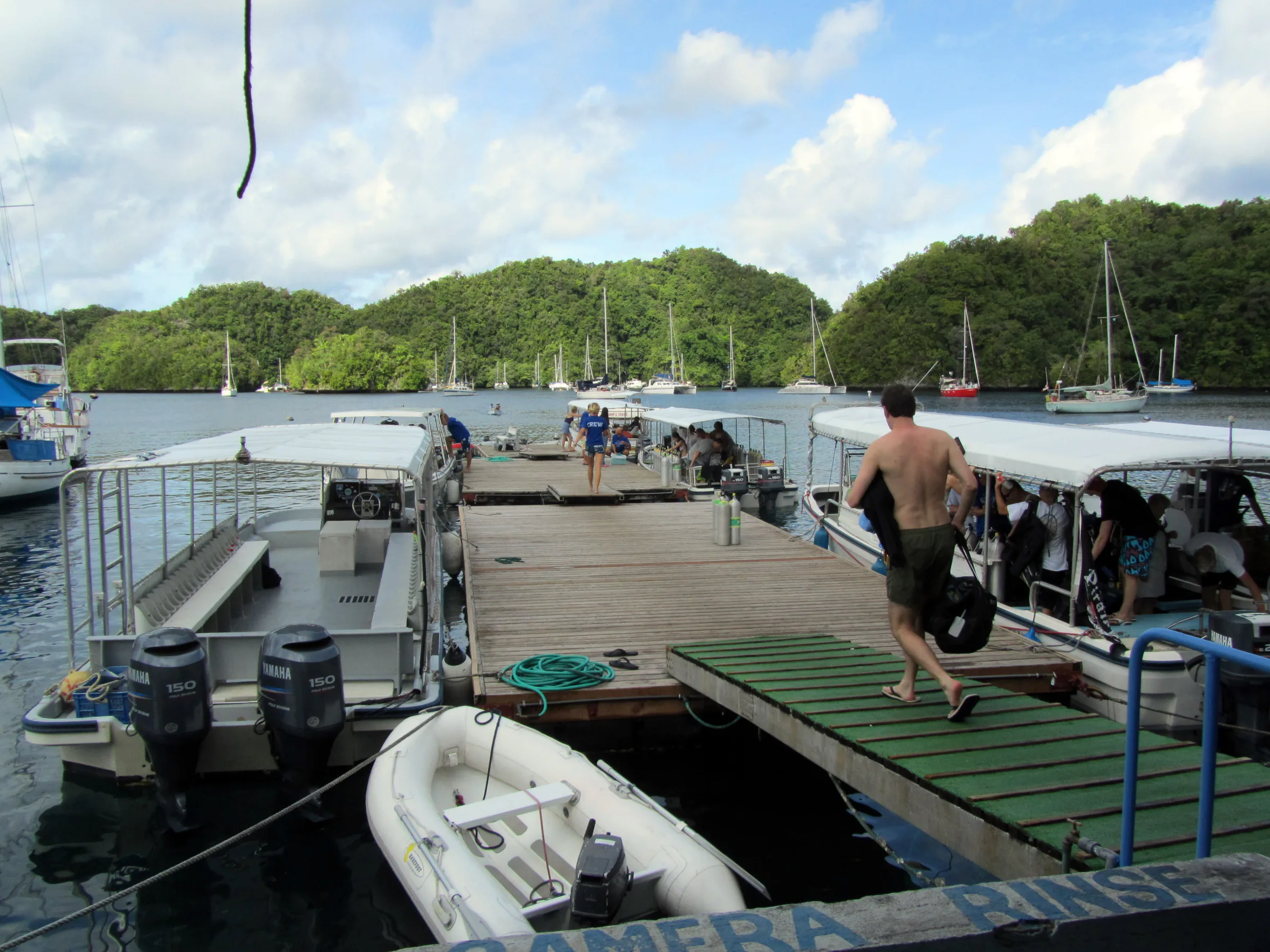 Loading some of the early morning diveboats at Sam's Tours. Yachts from sailors around the Pacific are moored in the background.
