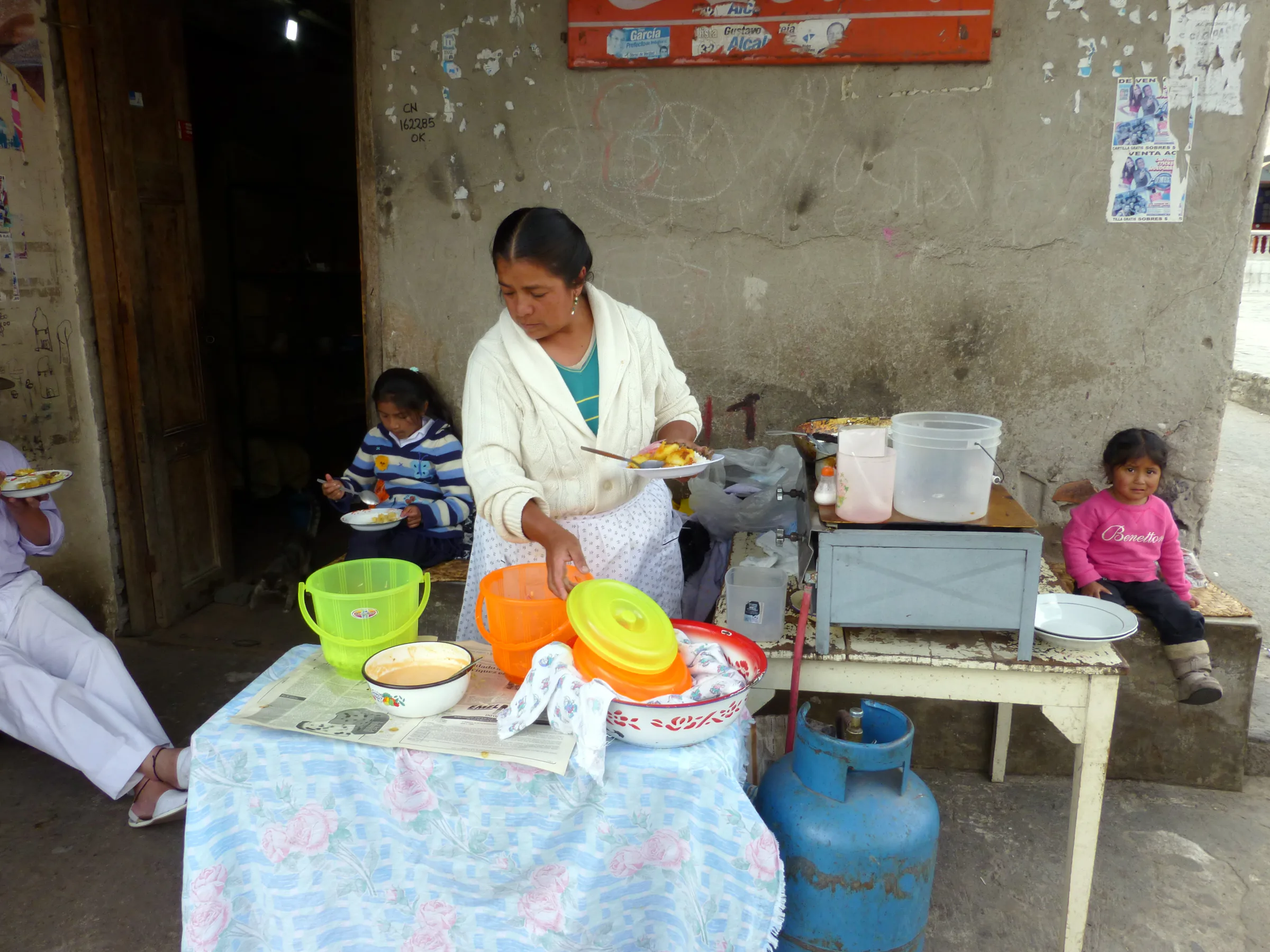 Outdoor restaurant on the square across the street from the Jose Ruiz Perugachi family shop. She is cooking a traditional Otavalo dish that our driver Lincoln later ordered for his lunch.