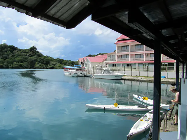 This is the front of the Fish 'n Fins dive shop seen at mid-day.  The divers have long departed, and three sailors from the USS Cowpens are about to depart on their rented kayaks.