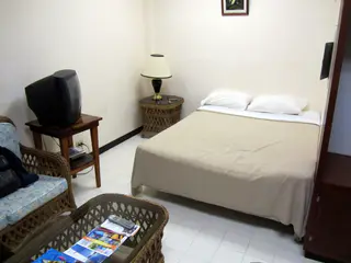 We stayed in clean, budget accommodations - the Guest Lodge Motel in central Koror, Palau.  "The Guest Lodge Motel offers a nice and clean place to stay if you just need a place to sleep and relax between days of outdoor activities.  Note that the building looks a bit shoddy from the outside, because the top floor is not finished. Rooms have AC, refridgerator, Cable TV, 130 V as well as 230 V power outlets, shower/bath, towels etc." [Wikitravel.org]