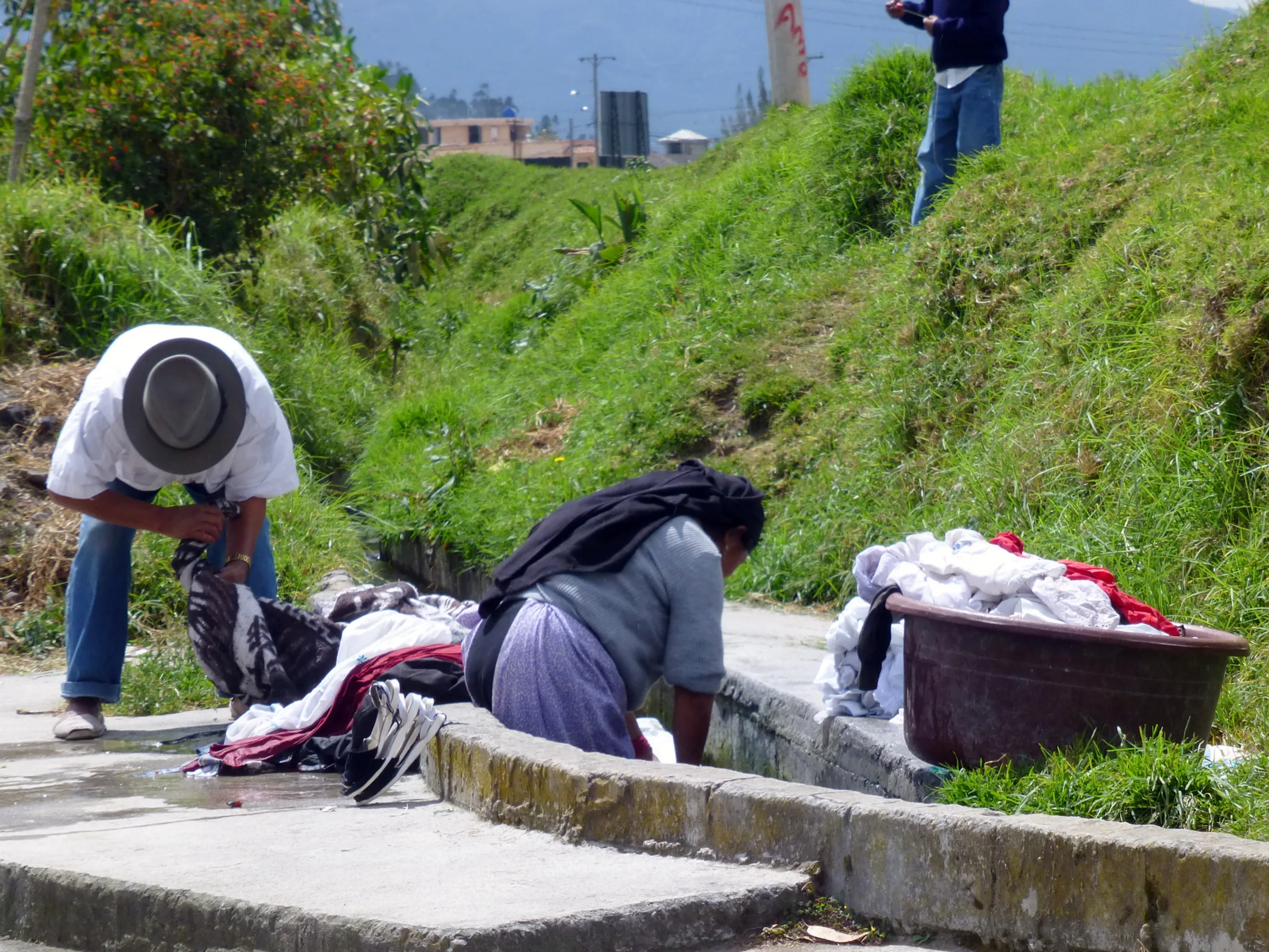 A family washes clothes along the road in Otavalo.