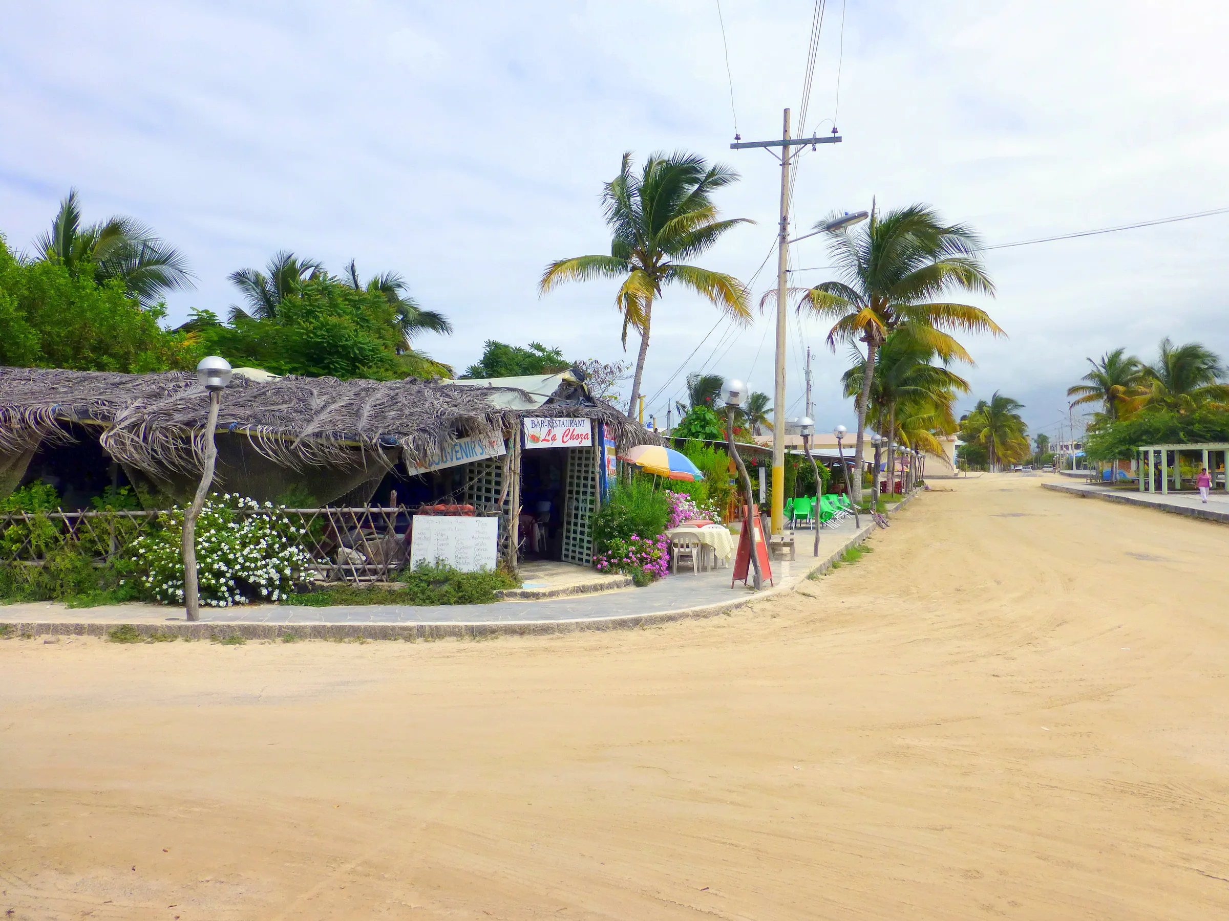 Sandy streets of Puerto Villamil.  Small restaurants line the town square where I took this photo.