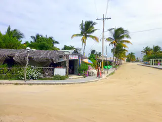 Sandy streets of Puerto Villamil. Small restaurants line the town square where I took this photo.