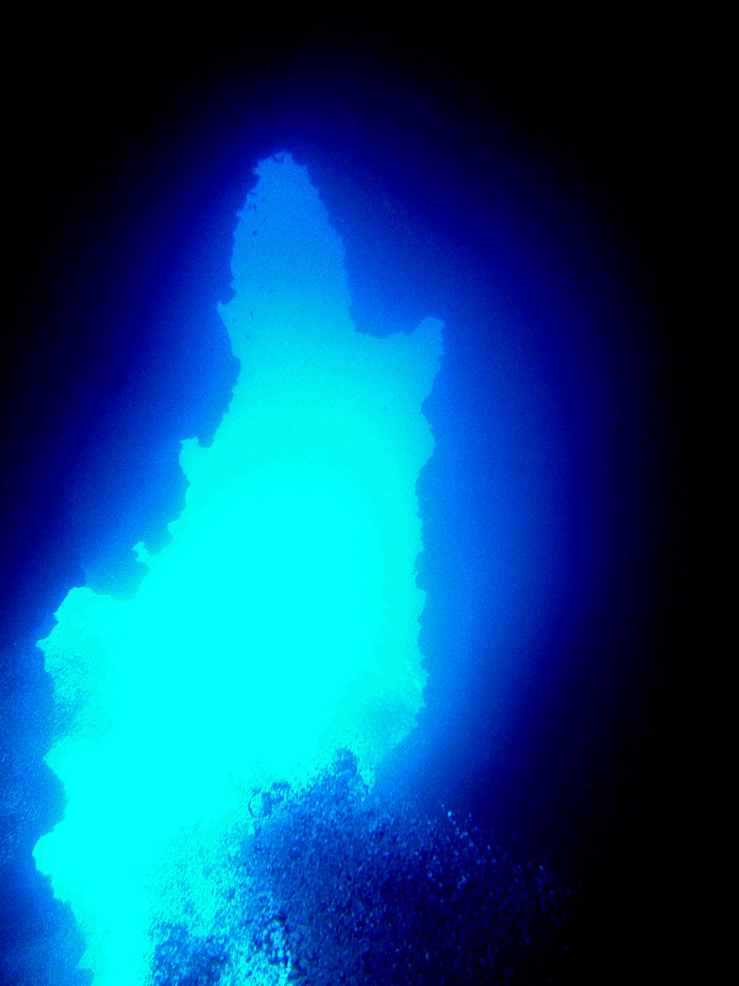 Looking from the cavern up at the entrance to the Virgin Blue Hole, Palau, from about 90'.