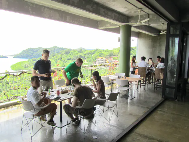 Sailors from the USS Cowpens prepare to depart their table on the balcony at the Elilai Restaurant.