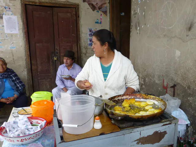 Outdoor restaurant on the square across the street from the Jose Ruiz Perugachi family shop.  She is cooking a traditional Otavalo dish that our driver Lincoln later ordered for his lunch.