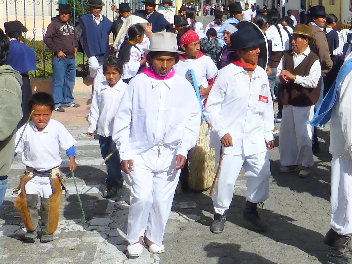 Procession.  Per wikitravel.org website, "Cotacachi Village is a small town of 20.000 inhabitants some 20km north of Otavalo. The town is famous for its leather goods."
