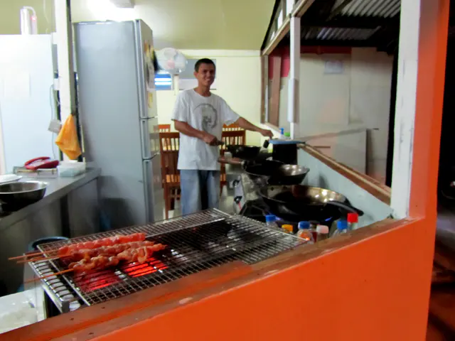 "I Love Noodles" Restaurant.  Satay pork and chicken on the grill.