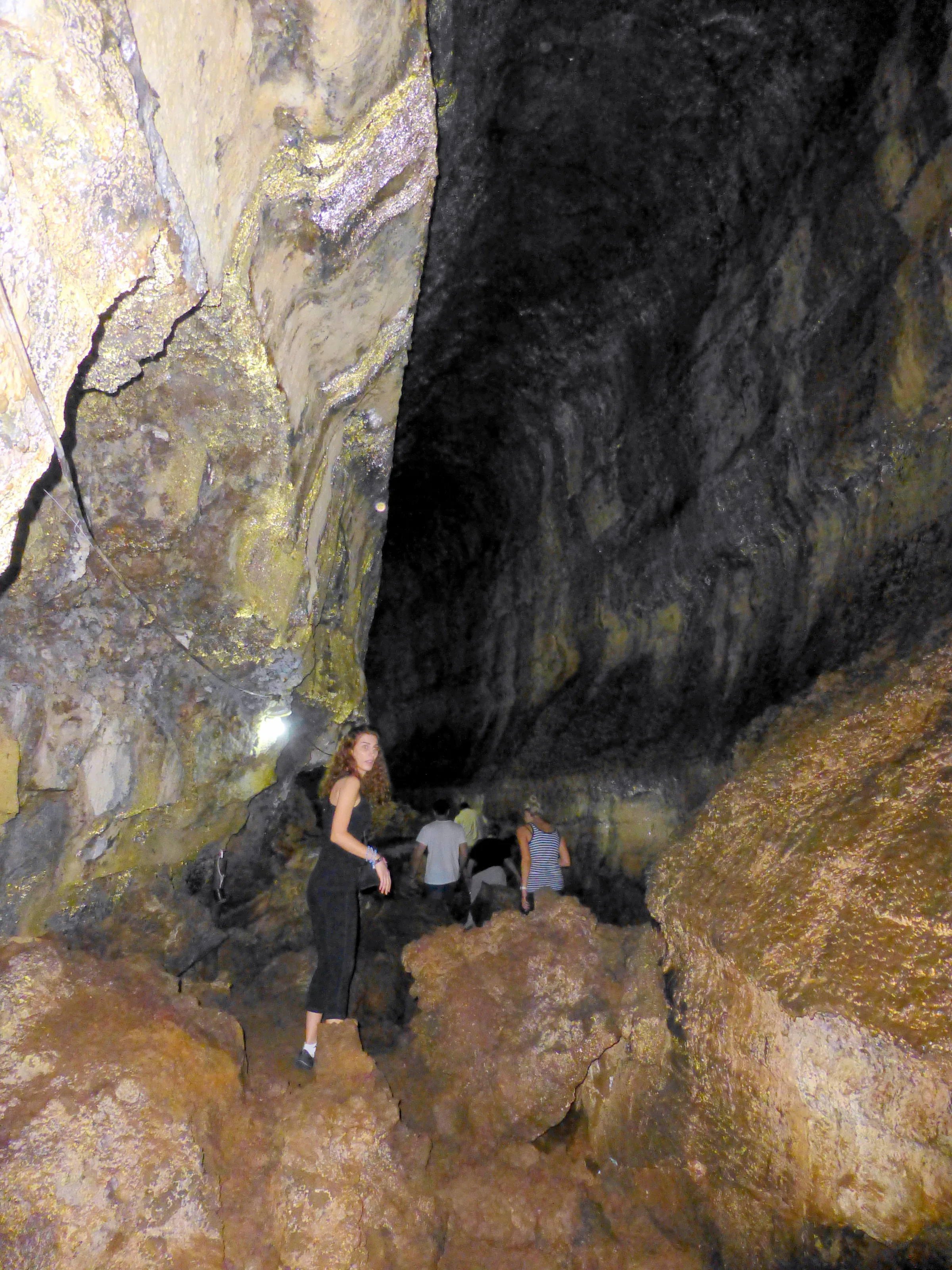 Climbing over boulders on the floor of the Lava Tunnel