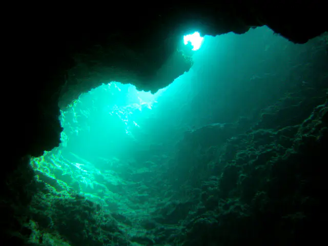 At the farthest end of the cave, there is a passageway up to the reef top.